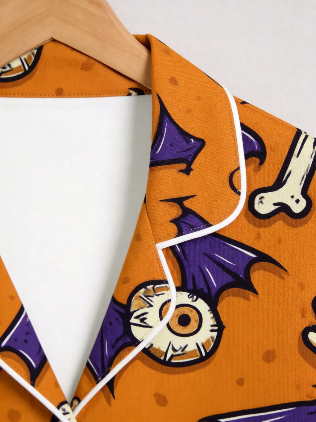 Orange Spooky Eyeball, Bone, and Bat Wing Print Pajama Set