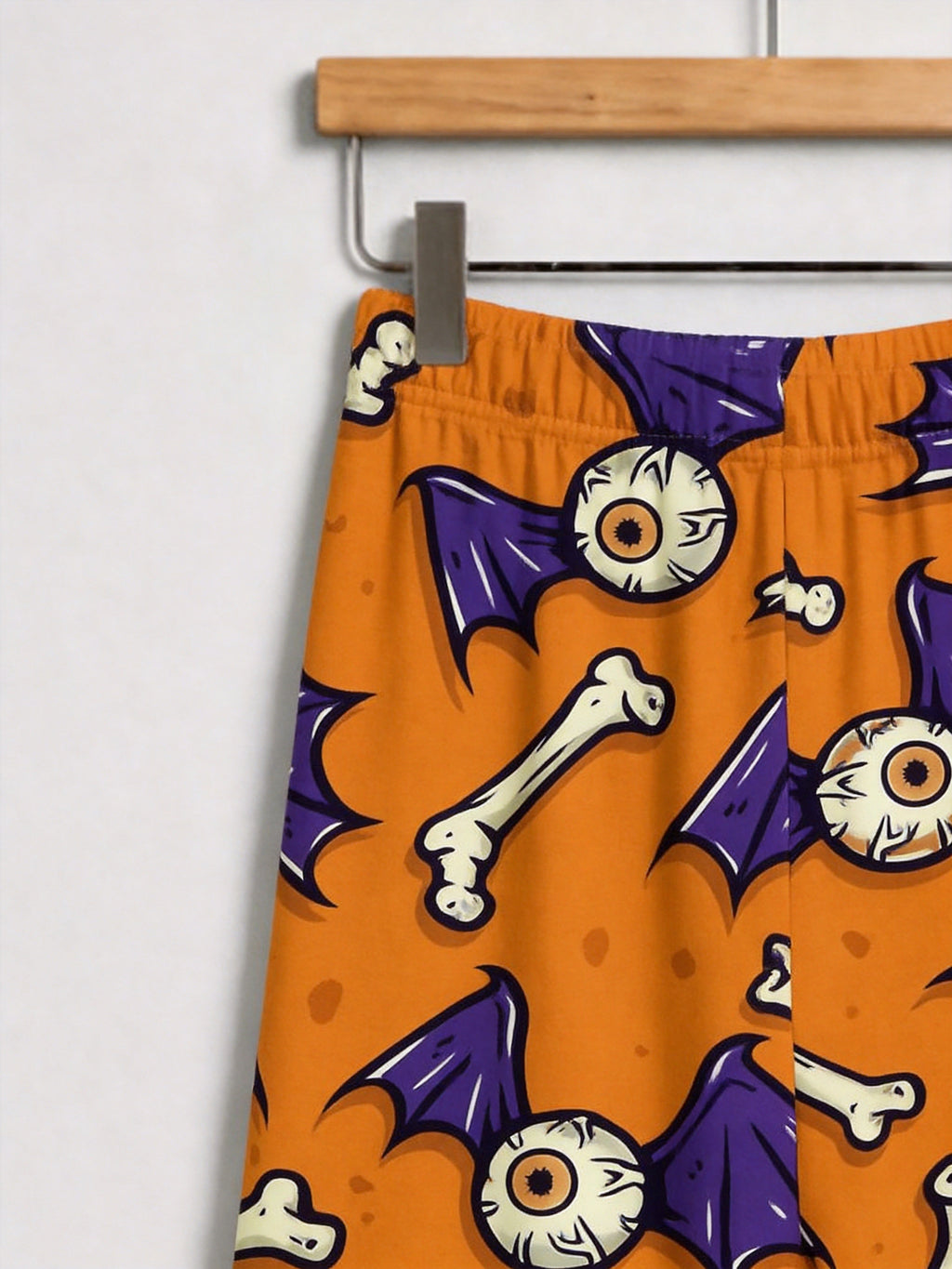 Orange Spooky Eyeball, Bone, and Bat Wing Print Pajama Set